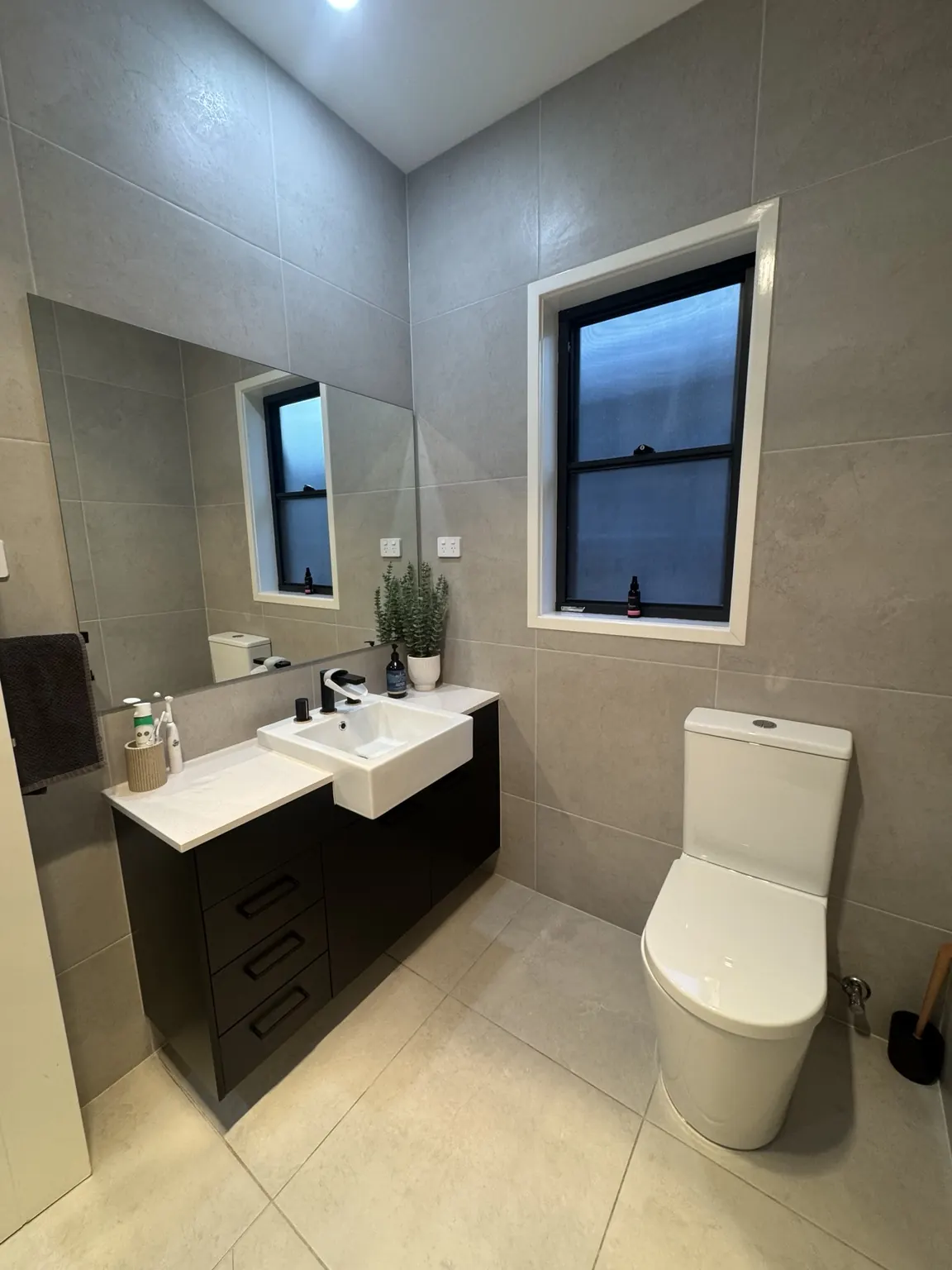 Clean bathroom vanity, mirror and toilet after a Marry a Mop clean