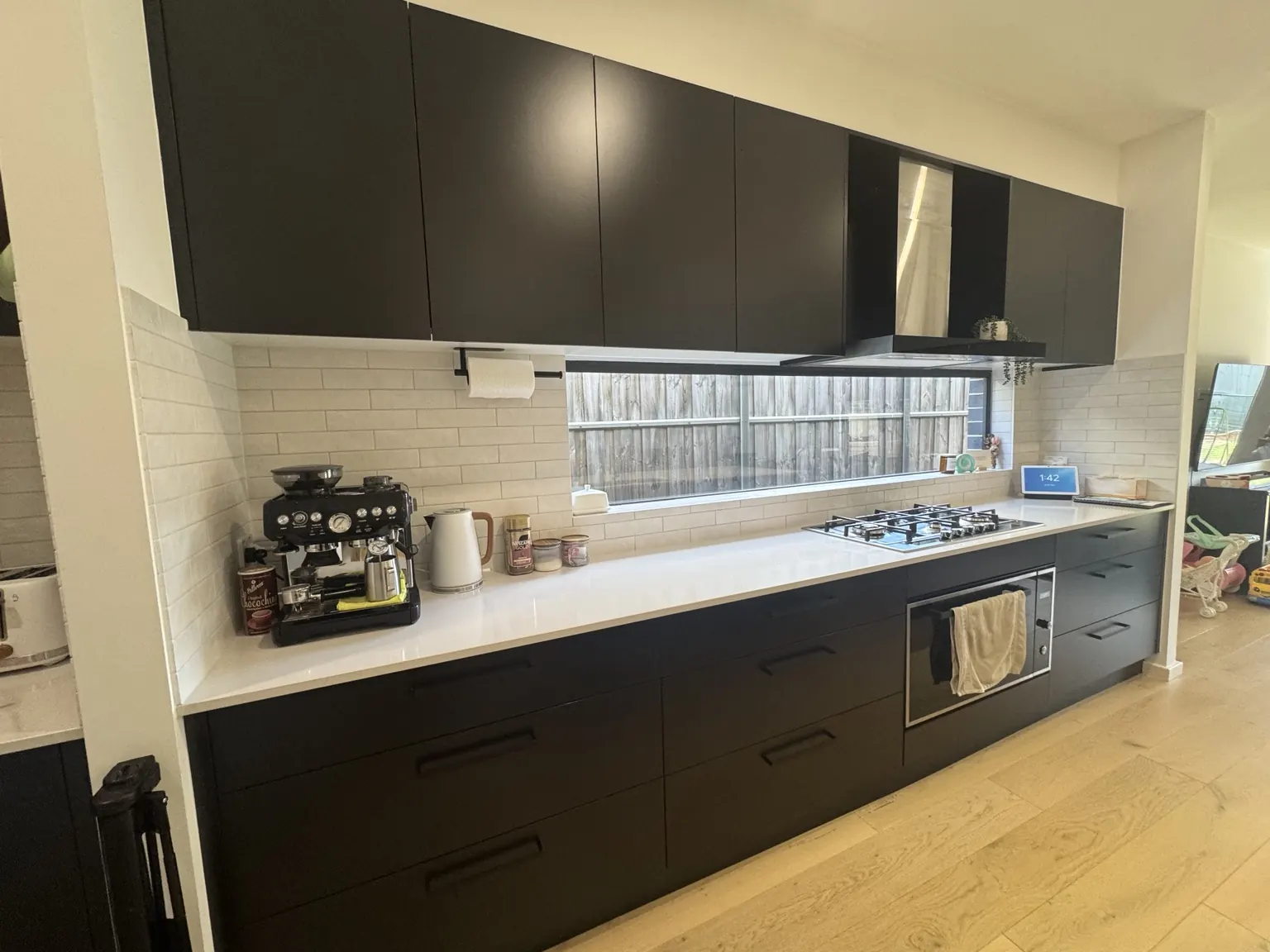 Detailed clean of black kitchen cabinetry and benchtop by Marry a Mop